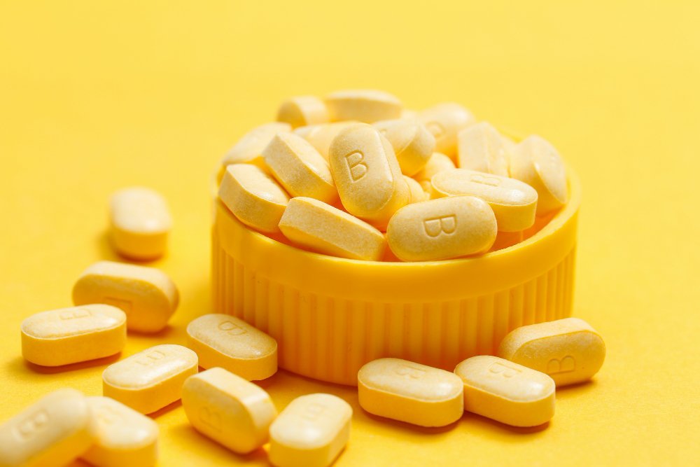 vitamin b tablets yellow background